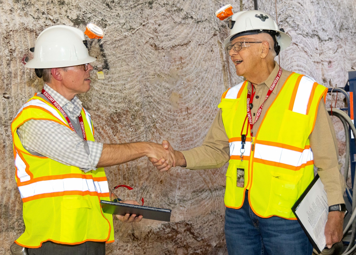 Ike White and John Heaton underground shaking hands